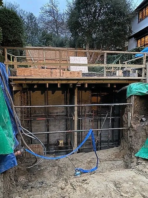 Formwork and propping for the retaining walls of a basement beside a garden